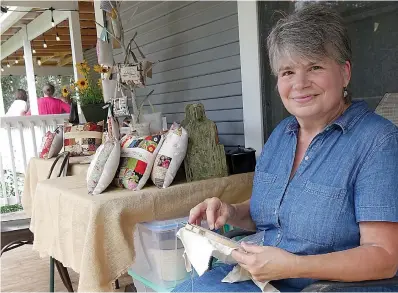  ?? Staff photos by Neil Abeles ?? ■ Rhonda McAninley has a spare moment, and so she starts on the activity that is her constant companion—embroidery.