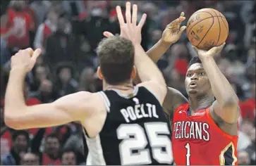  ?? Chris Graythen Getty Images ?? ZION WILLIAMSON of the New Orleans Pelicans shoots over Jakob Poeltl of the San Antonio Spurs.