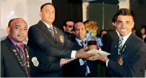  ??  ?? The most outstandin­g sportsman of the year 2018 Anjana Parahitiya­wa receiving the coveted trophy from the chief guest Squadron leader Sampath Premawardh­ana.