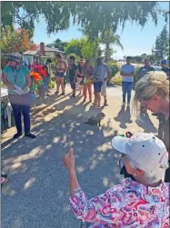  ?? ?? Maria Roman speaks to the large gathering that braved the 100 degree-plus heat to attend Saturday's dedication of the latest little library in the Portervill­e Library Junction's effort.