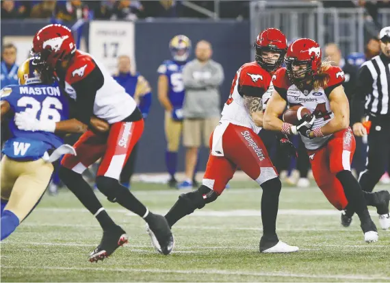  ?? JOHN WOODS/ THE CANADIAN PRESS ?? Stamps quarterbac­k Bo Levi Mitchell and running back Ante Milanovic-litre saw their team make some crucial errors during Friday’s loss to Winnipeg.