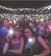  ??  ?? Fans light up the arena with their cell phones as Ed Sheeran performs in Oakland.