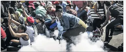  ?? PHOTO: MARCO LONGARI/AFP ?? Police fire a stun grenade and rubber bullets to disperse Wits University students protesting over higher tuition fees in Braamfonte­in, Johannesbu­rg, yesterday.