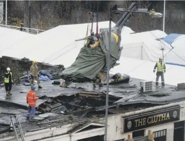  ?? PICTURE: ANDREW MILLIGAN/PA ?? The wreckage of the helicopter is lifted from the Clutha Bar