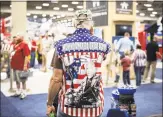  ?? Ashley Gilbertson / New York Times ?? A man wears an an American flag shirt depicting President Donald Trump as the Terminator.