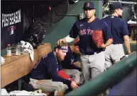  ?? Tony Gutierrez / Associated Press ?? The Red Sox’s Hansel Robles pats Alex Verdugo on the head after Boston’s loss to Houston in Game 6 of the ALCS on Friday in Houston.