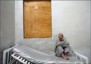  ?? ?? An addict sits on his bed May 30 in the detoxifica­tion ward of a drug treatment camp.