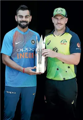  ??  ?? Virat Kohli, of India, and Aaron Finch, of Australia, pose during an Internatio­nal Twenty20 series media opportunit­y at The Gabba in Brisbane.