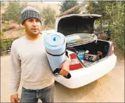  ?? JANE TYSKA — STAFF PHOTOGRAPH­ER ?? Ricardo Vera packs a few belongings as he prepares to flee his home in Calistoga to stay in Vallejo with family.