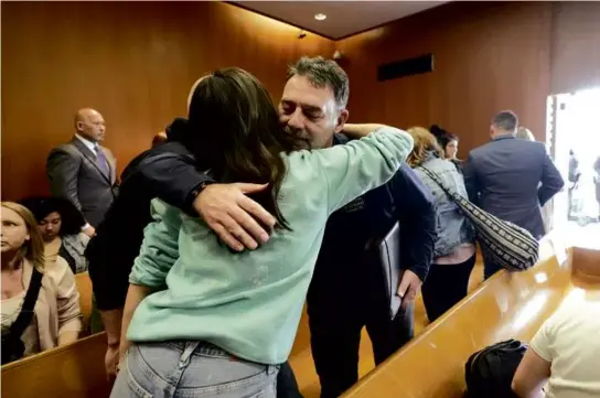  ?? CARLOS OSORIO/ASSOCIATED PRESS ?? Victims’ family and friends embraced after the parents of Ethan Crumbley were sentenced Tuesday in Pontiac, Mich.