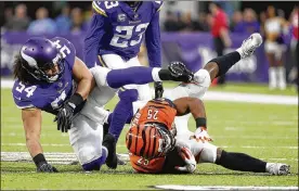  ?? BRUCE KLUCKHOHN / AP ?? Bengals running back Giovani Bernard, who rushed for 30 yards and a TD on 14 carries, is tackled by Vikings linebacker Eric Kendricks (54) on Sunday.