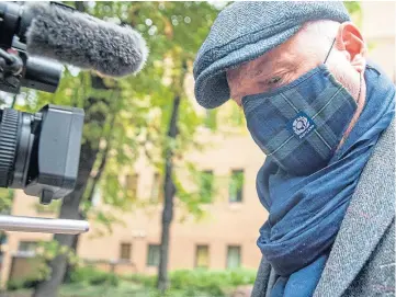  ??  ?? ON TRIAL: Wearing a Scotland mask, John Leslie leaves Southwark Crown Court.