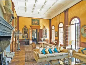  ??  ?? A sitting room on the ground floor provides a reminder of the home’s former owners, especially King Leopold II, whose blue-and-gold sigil is mounted on one of the silk-covered walls. Portraits of his infamous mistress, Blanche Delacroix, a former...