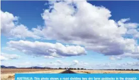  ??  ?? AUSTRALIA: This photo shows a road dividing two dry farm paddocks in the droughthit area of Quirindi in New South Wales. — AFP