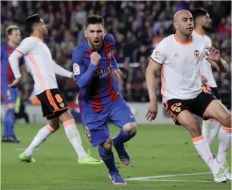  ?? — AP ?? BARCELONA: FC Barcelona’s Lionel Messi, center, celebrates after scoring a goal during the Spanish La Liga soccer match between FC Barcelona and Valencia at the Camp Nou stadium in Barcelona, Spain, Sunday.