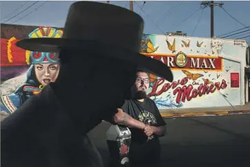  ?? Rick Loomis Los Angeles Times ?? ADRIAN ULLOA, 21, teaches graffiti art at the Boyle Heights nonprofit Soledad Enrichment Action. Behind him is his mural “Love our Mothers,” a work devoted to the community and to all mothers worldwide.