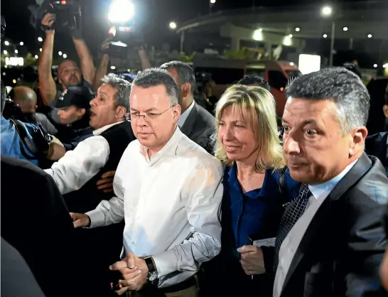  ?? AP ?? Andrew Brunson and wife Norine arrive at Adnan Menderes Airport for a flight to Germany after his release following his trial in Izmir, Turkey. The evangelica­l Christian pastor was convicted of terror charges but released from house arrest and allowed to leave Turkey, in a move likely to ease tensions between Turkey and the United States.