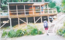  ?? Picture / Supplied ?? Wanganui trampers approach a Orongorong­o Valley hut on an earlier club visit.