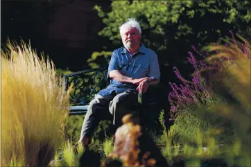  ?? RAY CHAVEZ — STAFF PHOTOGRAPH­ER ?? COVID-19 survivor Cliff Morrison sits in a garden in his Oakland neighborho­od in June 2020. Morrison is participat­ing in a UC San Francisco study on the long-term fallout of COVID-19 and has found comfort in the doctors there.