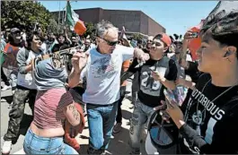  ?? JOSH EDELSON/GETTY-AFP ?? Protesters surround a man as he leaves a rally where Donald Trump spoke in Fresno, Calif., on Friday. A Trump rally in San Diego that day also drew protesters and police.