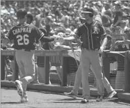  ?? Bay Area News Group/tns ?? The Oakland Athletic’s Matt Chapman is greeted by teammate Stephen Piscotty after scoring on a 2-run, third inning double by Matt Olson against the San Francisco Giants, Wednesday at Oracle Park in San Francisco.