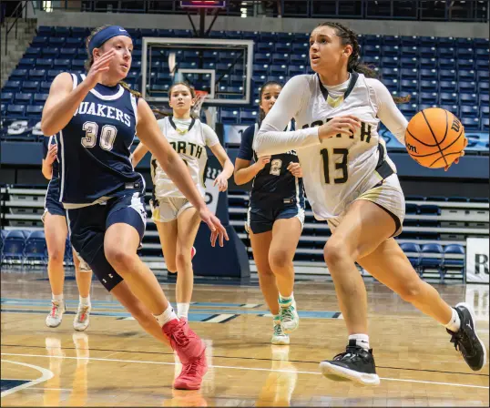  ?? ?? Above: North Kingstown’s Jaelyn Holmes drives past Moses Brown’s Lauren Bousquet.