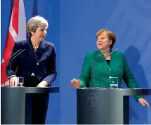  ?? — AP ?? German Chancellor Angela Merkel, ( right), and British Prime Minister Theresa May arrive for a press conference after a meeting in the chanceller­y in Berlin on Friday.