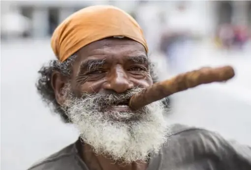  ??  ?? Who wouldn't want to hang with the locals in Havana? (Getty)