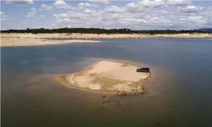  ??  ?? A newly revealed piece of land due to receding waters at the drought-stricken Folsom Lake in Granite Bay, California. Photograph: Josh Edelson/AP