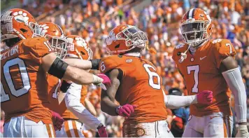  ?? KEN RUINARD/USA TODAY SPORTS ?? Clemson linebacker Mike Jones Jr. (6) celebrates an intercepti­on during last week's win over Syracuse. The Tigers have allowed just 13.5 points per game this season.