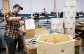  ?? Lucy Schaly/Post-Gazette ?? A Steubenvil­le, Ohio, resident builds honeycomb shelving in the workshop at the College of St. Joseph the Worker in Steubenvil­le. The workshop is open to community members along with those on campus.