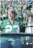  ??  ?? Ron Lancaster’s daughter Lana Mueller with the Grey Cup in Mosaic Stadium on Saturday.