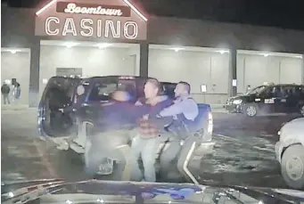  ??  ?? A still from RCMP vehicle dashboard-camera footage showing officers arresting Chief Allan Adam outside a casino in Fort McMurray, Alta., in March.