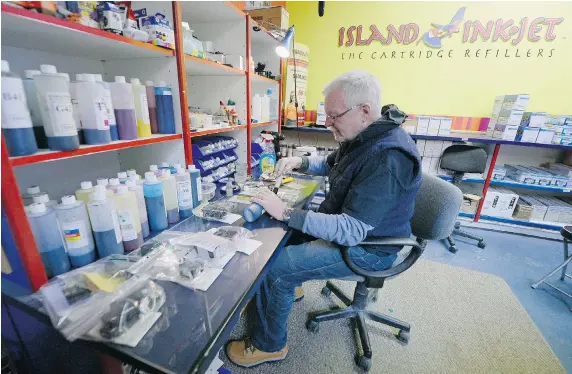  ?? TROY FLEECE/Leader-Post ?? Merton Moore, owner of Island Ink Jet in the Golden Mile Centre, refills an ink cartridge Tuesday in Regina. Moore has received an eviction notice to shut down his kiosk by Feb. 20.