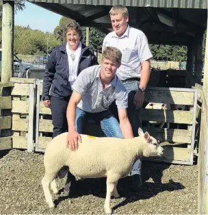  ?? PHOTO: SUPPLIED ?? Meeting the market . . . Michael Robinson holds the Beltex ram lamb for which he and his parents AnnMaree and Brent paid $21,000.