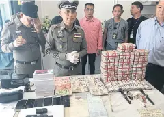  ??  ?? MADE-UP BUSINESS: Police display bundles of cash and valuable items seized during a crackdown on a network selling sub-standard skin care and weight loss products.