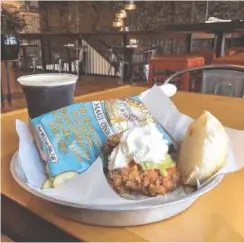  ?? PHOTO BY JIM TANNER ?? Fried chicken breast sandwich is drizzled with house-made buffalo sauce and topped with celery salad and whipped buttermilk dressing.