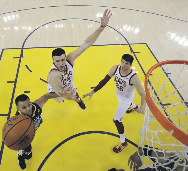  ??  ?? Golden State Warriors’ Stephen Curry, left, drives past the Cleveland Cavaliers defence in Game 2 of the NBA Finals in Oakland, California