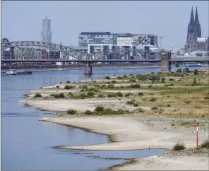  ?? The Associated Press ?? The river Rhine is pictured with low water in Cologne, Germany, Wednesday. The low water levels are threatenin­g Germany’s industry as more and more ships are unable to traverse the key waterway.