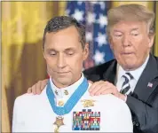  ?? ANDREW HARNIK — THE ASSOCIATED PRESS ?? President Donald Trump awards the Medal of Honor to Master Chief Special Warfare Operator Britt K. Slabinski.