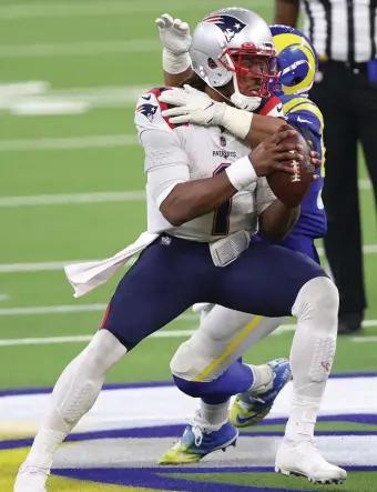  ?? Getty ImaGes ?? RAM TOUGH: Cam Newton is sacked by Aaron Donald during Thursday night’s loss.