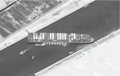  ?? CNES2021, DISTRIBUTI­ON AIRBUS DS ?? This satellite image shows the massive cargo ship Ever Given stuck Thursday in the Suez Canal. Now the business of determinin­g who will pay for clearing the vessel from the key shipping lane begins. The results may not be known for several years.