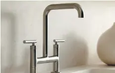  ??  ?? A bridge-style kichen faucet is a good example of form meeting function.