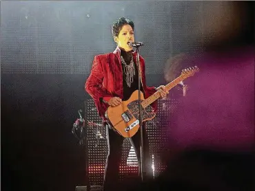  ?? STR / AFP VIA GETTY IMAGES ?? Prince performs on the main stage at the first day of Sziget (Island) Festival on August 9, 2011, on “Hajogyar” (Shipyard) Island in Budapest, Hungary.