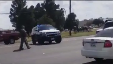  ?? DUSTIN FAWCETT- THE ASSOCIATED PRESS ?? In this image made from video provided by Dustin Fawcett, police officers guard on a street in Odessa, Texas, Saturday.