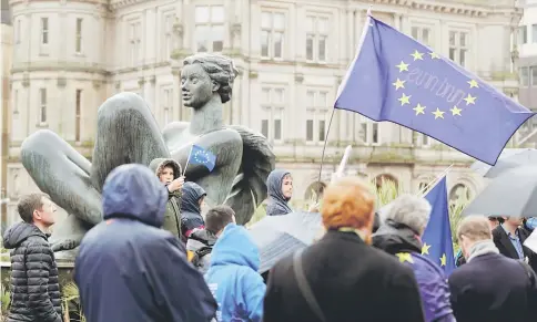  ?? — Reuters photo ?? Protesters wave Europen Union flags during an anti-Brexit demonstrat­ion after May triggered the process by which the United Kingdom will leave the Euopean Union, in Birmingham, Britain.