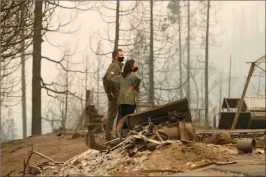  ?? AP PHOTO BY GARY KAZANJIAN ?? California Gov. Gavin Newsom and Democratic vice presidenti­al candidate Sen. Kamala Harris, D-calif., talk as they asses the damage during the Creek Fire at Pine Ridge Elementary, Tuesday, Sept. 15, in Auberry, Calif.