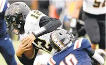  ?? STEPHEN M. KATZ/STAFF ?? Highland Springs’Juwan Dent, defended by Maury’s Taizuan Brown, runs a quarterbac­k keeper during Saturday’s Class 5 state semifinal game at Powhatan Field.