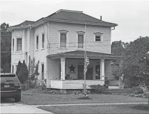  ?? CRAIG SHOUP/NEWS-MESSENGER ?? A U.S. flag flies at half staff Friday at the Soviak home in Berlin Heights.