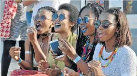  ?? Picture: IVOR MARKMAN ?? GREAT SOUNDS: Friends from left, Limpo Sonica, Vuyolwethu Zanekile, Mtha Poni and Sihle Kwanini listen attentivel­y to the music of Ohayv during the Alliance Française Street Music Festival in Richmond Hill last Saturday